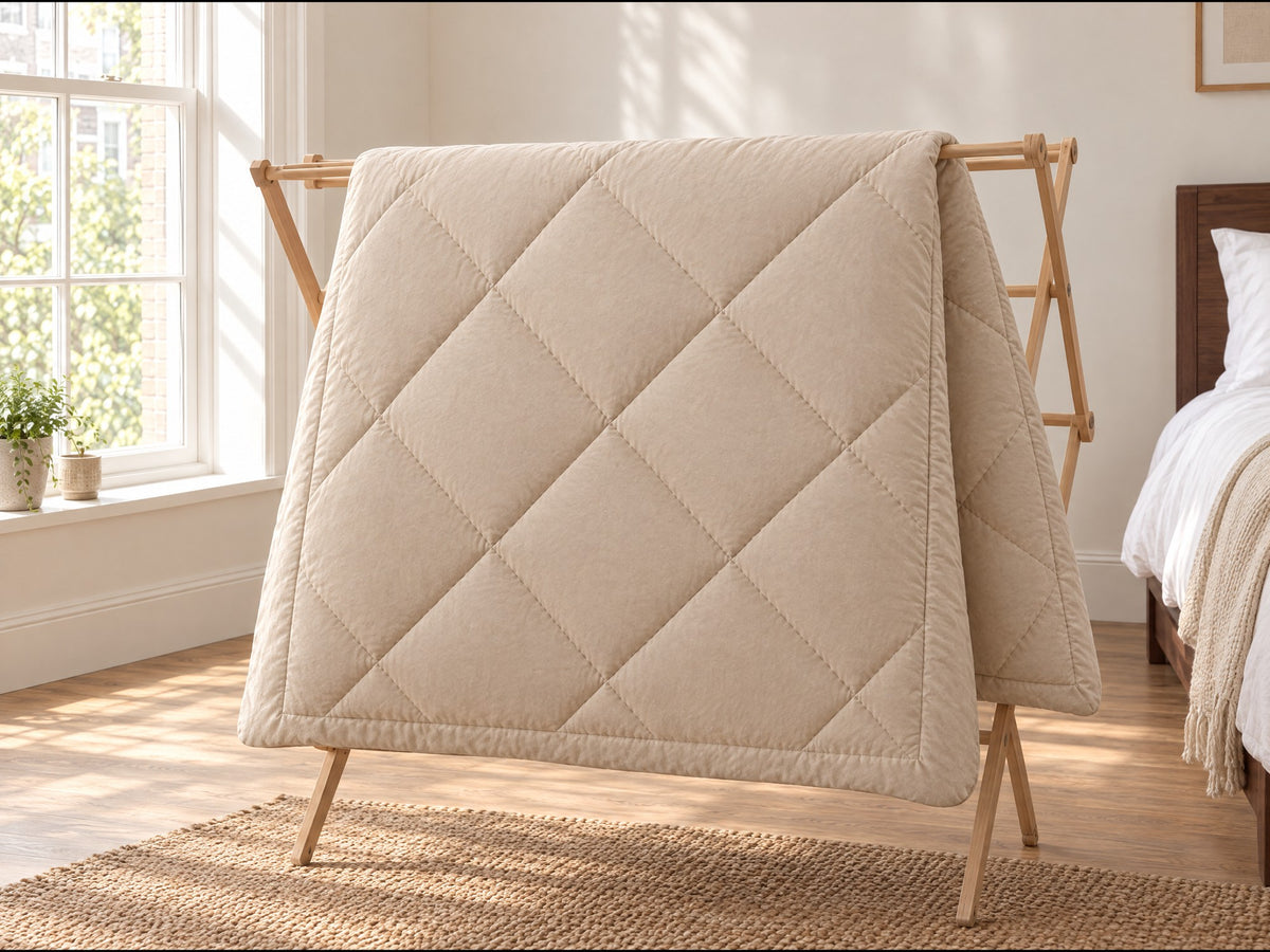 The Duvenna duvet drying on an airer by a window Image
